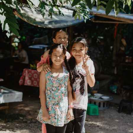 cheerful little asian kids spending time on street