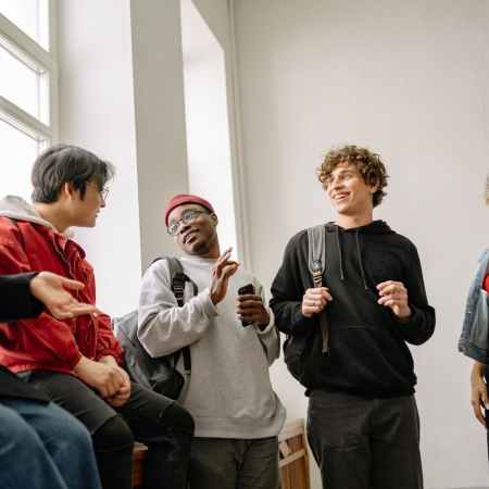 students talking while on a staircase landing